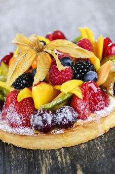 Fresh dessert fruit tart covered in assorted tropical fruits