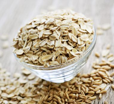 Nutritious rolled oats heaped in a glass bowl