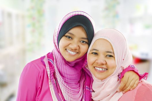 Happy Muslim women standing inside house