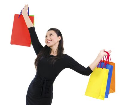 Happy shopper holding shopping bag high isolated on white background