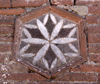 A brick decoration in the wall in the ruins of the Roman city of Pompeii.  It was completely buried by an eruption of Mount Vesuvius in AD 79.
