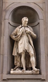 A statue of Michelangelo (Michelangelo di Lodovico Buonarroti Simoni) sitting outside of the Uffizi, in Florence, Italy.  Michelangelo was a  sculptor, painter, architect, poet, and engineer  during the Italian Renaissance. 

