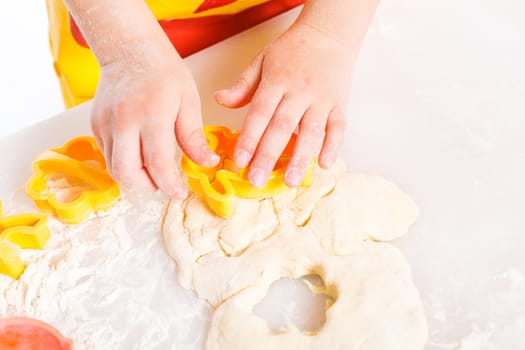 Beautiful hand boys making a cake, isolated on white background.