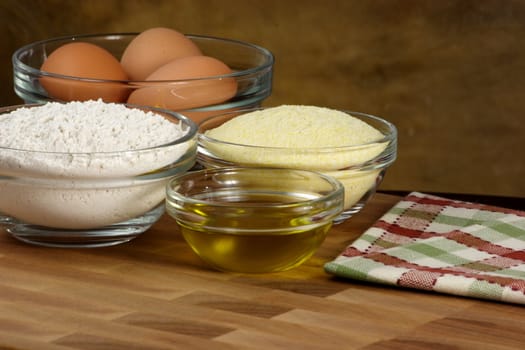 fresh raw tortellini ingredients on kitchen wood station with utensils