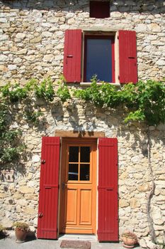 House in typical provencal style in France, windows with wooden shutters