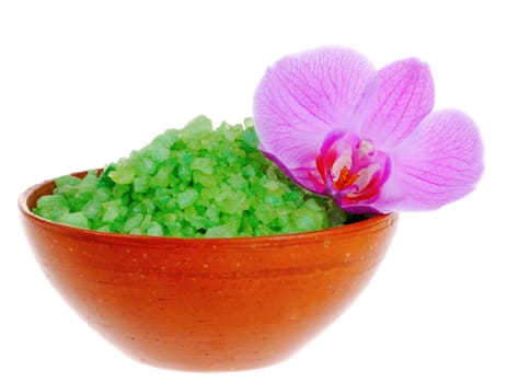 Old-fashioned dish with salt for bath and orchid flower on white background