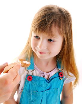 Small beauty girl is taking a white tablet in wooden spoon from female hand on white background