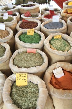 Various sorts of herbs and spices, displayed in bags on a french market