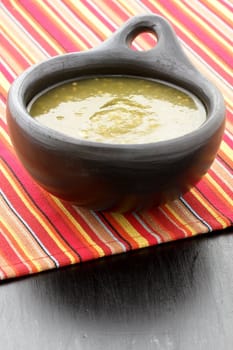 fresh delicious,flavorful tomatillo sauce in colombian clay dish