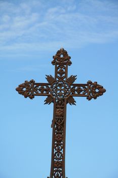 Old cast iron cross grave ornament on an old cemetery in the Provence, France