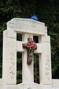 Gravestond on an old french cemetery with ceramic flowers