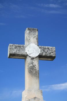 Stone cross grave ornament on an old cemetery in the Provence, France