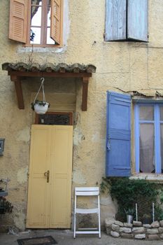 House in typical provencal style in France, windows with wooden shutters