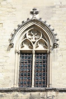 Detail of the facade of the Palais du Pape, ancient castle of the popes in Avignon, France, window with stained glass