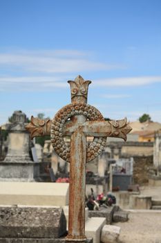 Cross ornament in a grave in the Provence, France, made of cast iron. 