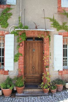 House in typical provencal style in France, windows with wooden shutters