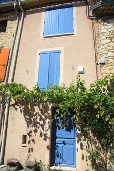 House in typical provencal style in France, windows with wooden shutters