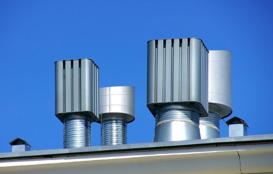 Ventilation on a roof on a background of the blue sky