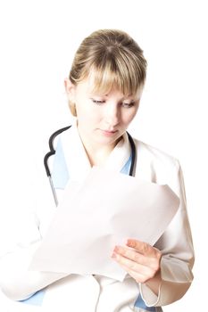 Doctor with  stethoscope takes notes on  white sheet of paper