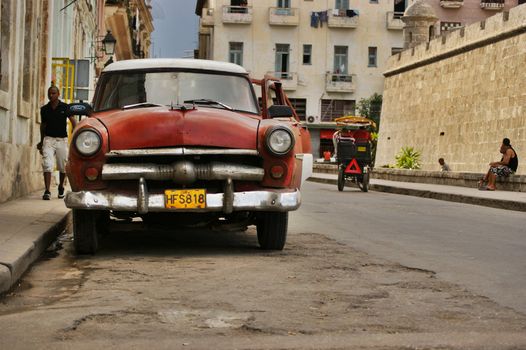 An old american car parked beside the road in Old Havane