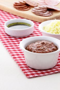 Classic delicious pizza ingredients on nice table setting