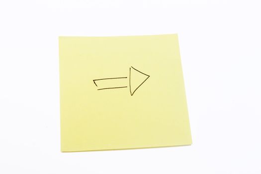 Arrow on a yellow sticky note isolated on white