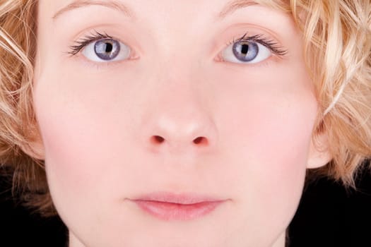 Closeup of a pretty blond girl's face with blue eyes