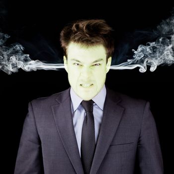 Furious businessman getting green isolated on black