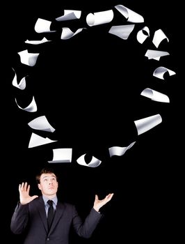 Businessman manipulating sheets of paper isolated on black background