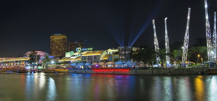 SINGAPORE, SINGAPORE - MAR 13 : Nightlife at Clarke Quay Along Singapore River Panorama on Mar 13, 2013. A popular tourist attraction in Singapore with boat rides restaurants night clubs and shopping mall.