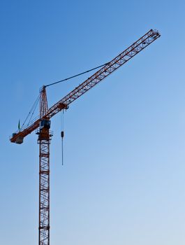 Hoisting crane on blue sky background