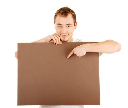 Young man shows by finger on a brown empty board for your text
