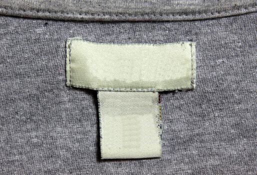 A grey shirt and a white label.
