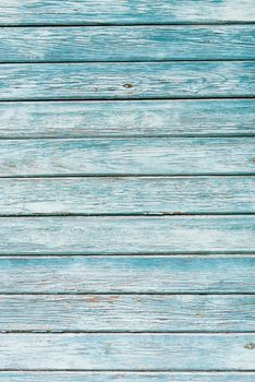 Blue painted house wall with chapped surface