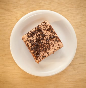 chocolate cake with plate on wood background