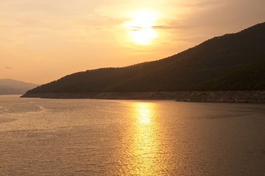 Sunset at The Bhumibol Dam(formerly known as the Yanhi Dam) in Thailand. The dam is situated on the Ping River and has a capacity of 13,462,000,000 cubic meter.