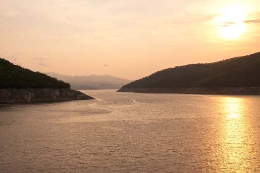 Sunset at The Bhumibol Dam(formerly known as the Yanhi Dam) in Thailand. The dam is situated on the Ping River and has a capacity of 13,462,000,000 cubic meter.