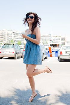 Photo of a young, beautiful and cheerful girl who jumps high sunny summer day