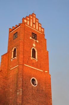 Red brick wall clock tower from the medieval period.