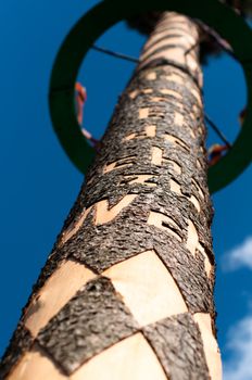 Richly decorated and engraved may pole on sky background
