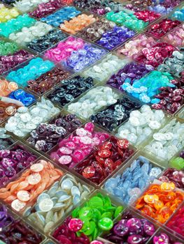 Various colorful buttons in plastic box for sell