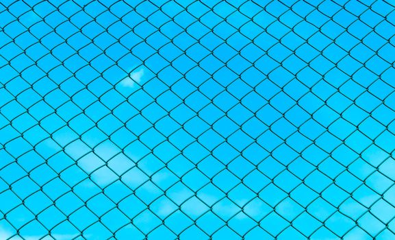 chain fence with blue sky on the back