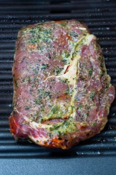Marinated entrecote steak freshly put on the barbecue