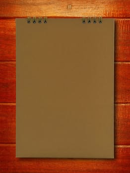 brown notebook on wood background