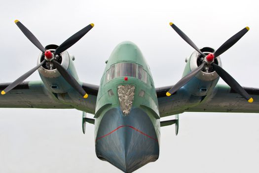 Amphibious turboprop plane on takeoff on sky background