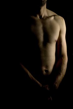 sexy fit naked male body on black background low key