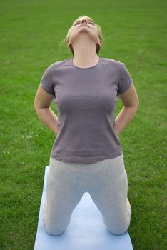 middle aged woman keeping fit with exercises in a park