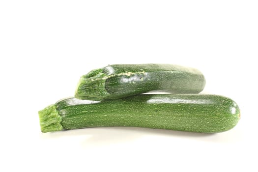 green whole zucchini on a light background