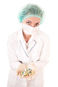 Serious doctor with pills in hands isolated on white background