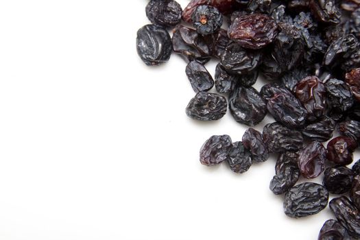 black raisins on a white background